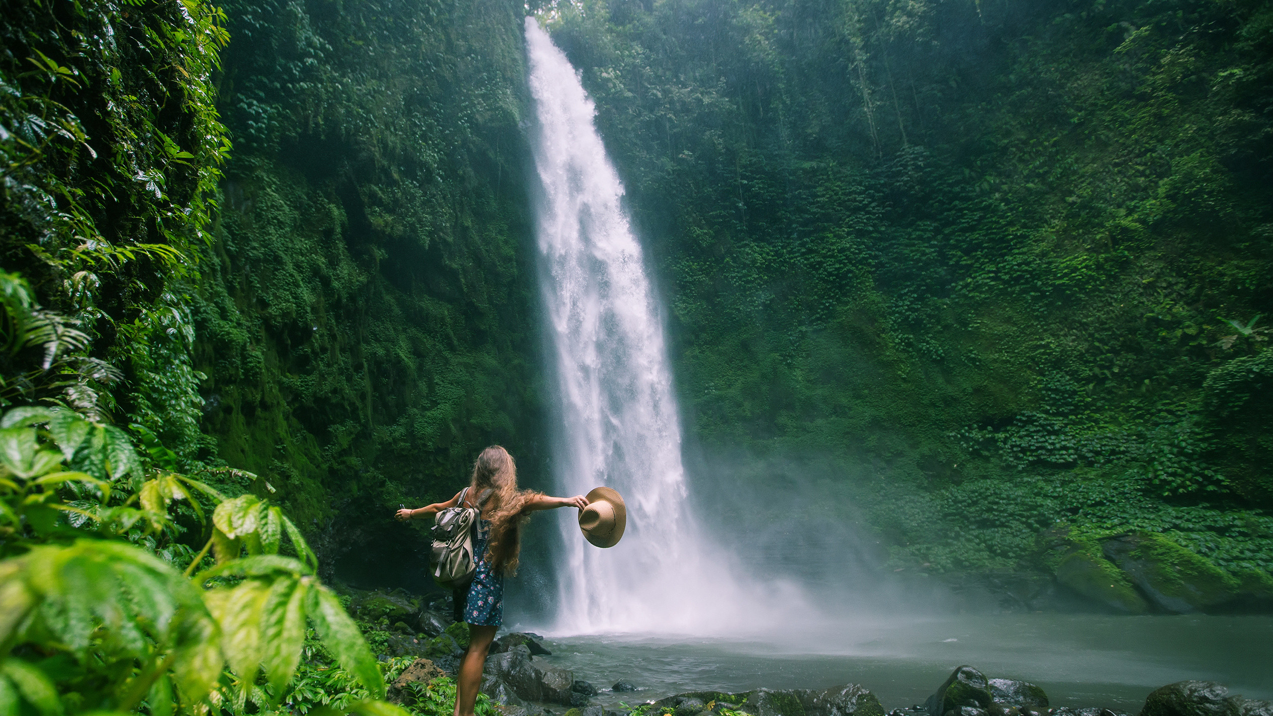 Woman standing by the waterfall