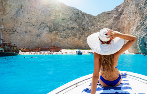 Female traveller with white sun hat exploring an island