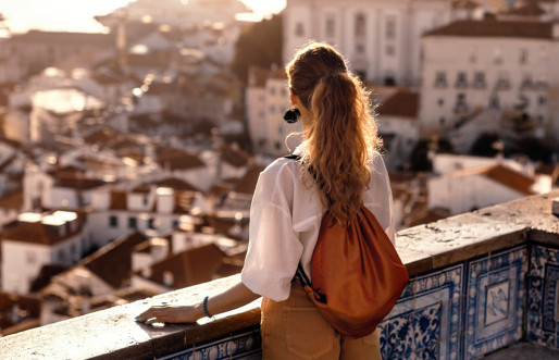 A female tourist strolling through an Iberian city, pausing at iconic landmarks for breathtaking photo opportunities.