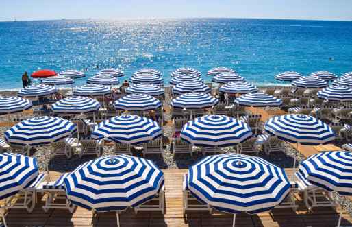 White and blue beach umbrellas on the French Riviera